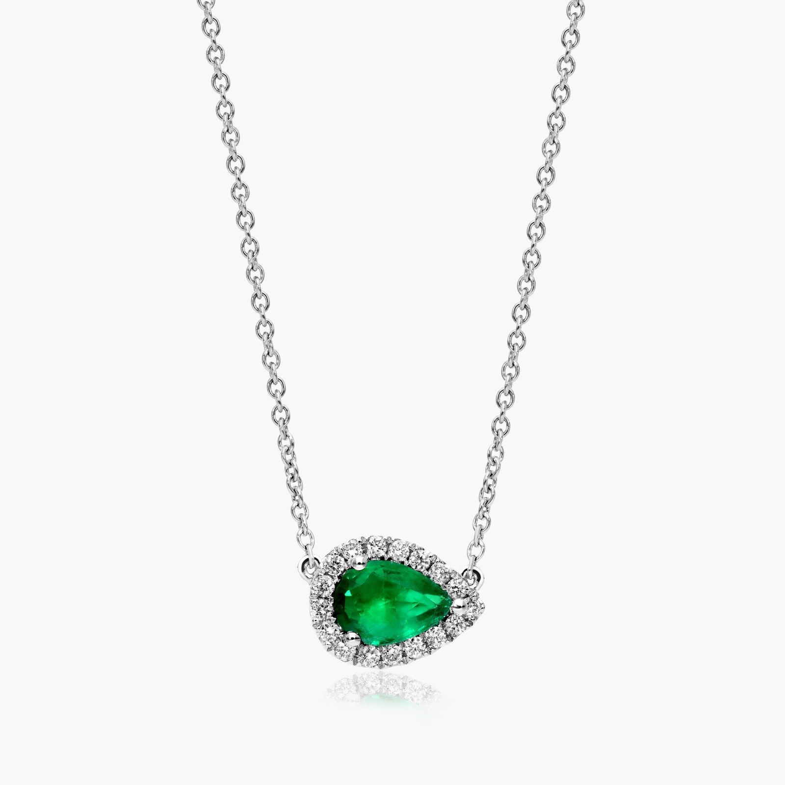 An East-West Pear Emerald (0.65 CT min) and Diamond Halo Necklace (0.14 CTW) in 18K White Gold, a modern and high-quality option among Luxury Push Present Ideas.