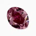 A GIA-certified 0.61 carat Oval Fancy Vivid Purplish Pink Diamond with VS2 clarity, offered by Blue Nile.