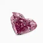 A GIA-certified 0.66 carat Heart Shape Fancy Vivid Purplish Pink Diamond with IF clarity, a rare piece among Loose Pink Diamonds For Sale.