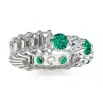 An Alternating Emerald Paradox Eternity Band from Charles & Colvard, featuring alternating lab-grown round and emerald-cut stones with emerald color accents, a unique option among Luxury Push Present Ideas.