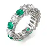 An Alternating Emerald Paradox Eternity Band from Charles & Colvard, featuring alternating lab-grown round and emerald-cut stones with emerald color accents, a unique option among Luxury Push Present Ideas.