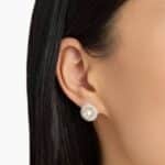 A model wearing the large 8.5mm Akoya Pearl and Diamond Double Halo Earrings, showcasing the impressive size and brilliant sparkle near the earlobe.