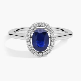 A Floating Oval Sapphire and Diamond Micropavé Halo Ring (7x5mm sapphire, 0.14 CTW diamond) in 14K White Gold, a colorful and elegant option among Luxury Push Present Ideas.