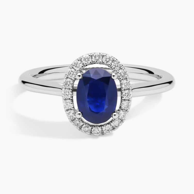 A Floating Oval Sapphire and Diamond Micropavé Halo Ring (7x5mm sapphire, 0.14 CTW diamond) in 14K White Gold, a colorful and elegant option among Luxury Push Present Ideas.