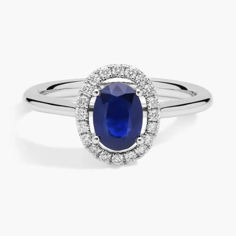 A Floating Oval Sapphire and Diamond Micropavé Halo Ring (7x5mm sapphire, 0.14 CTW diamond) in 14K White Gold, a colorful and elegant option among Luxury Push Present Ideas.
