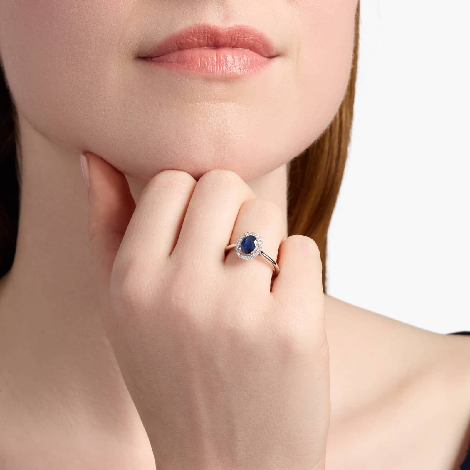 Floating Oval Sapphire and Diamond Micropavé Diamond Halo Ring in 14k White Gold model view A Floating Oval Sapphire and Diamond Micropavé Halo Ring (7x5mm sapphire, 0.14 CTW diamond) in 14K White Gold, a colorful and elegant option among Luxury Push Present Ideas.