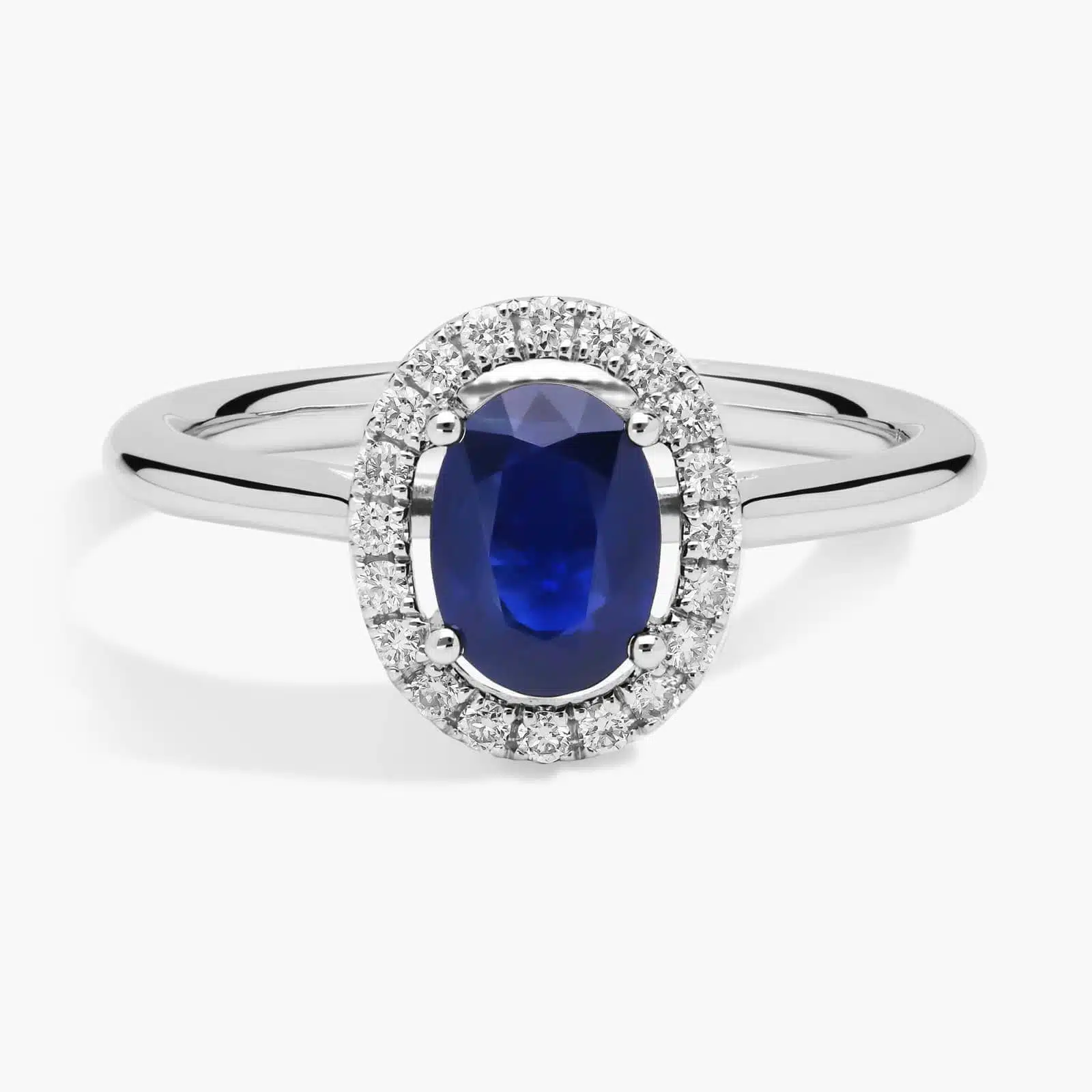 Floating Oval Sapphire and Diamond Micropavé Diamond Halo Ring in 14k White Gold A Floating Oval Sapphire and Diamond Micropavé Halo Ring (7x5mm sapphire, 0.14 CTW diamond) in 14K White Gold, a colorful and elegant option among Luxury Push Present Ideas.
