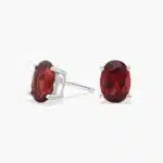 A pair of Oval Garnet Stud Earrings in 14K White Gold, a stylish and affordable option among Luxury Push Present Ideas and birthing gifts for mom.