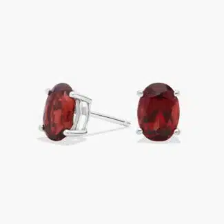 A pair of Oval Garnet Stud Earrings in 14K White Gold, a stylish and affordable option among Luxury Push Present Ideas and birthing gifts for mom.