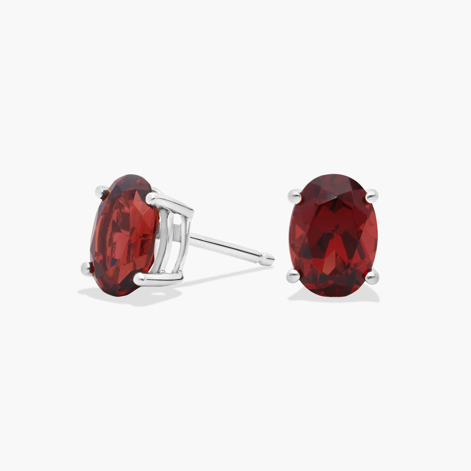 A pair of Oval Garnet Stud Earrings in 14K White Gold, a stylish and affordable option among Luxury Push Present Ideas and birthing gifts for mom.