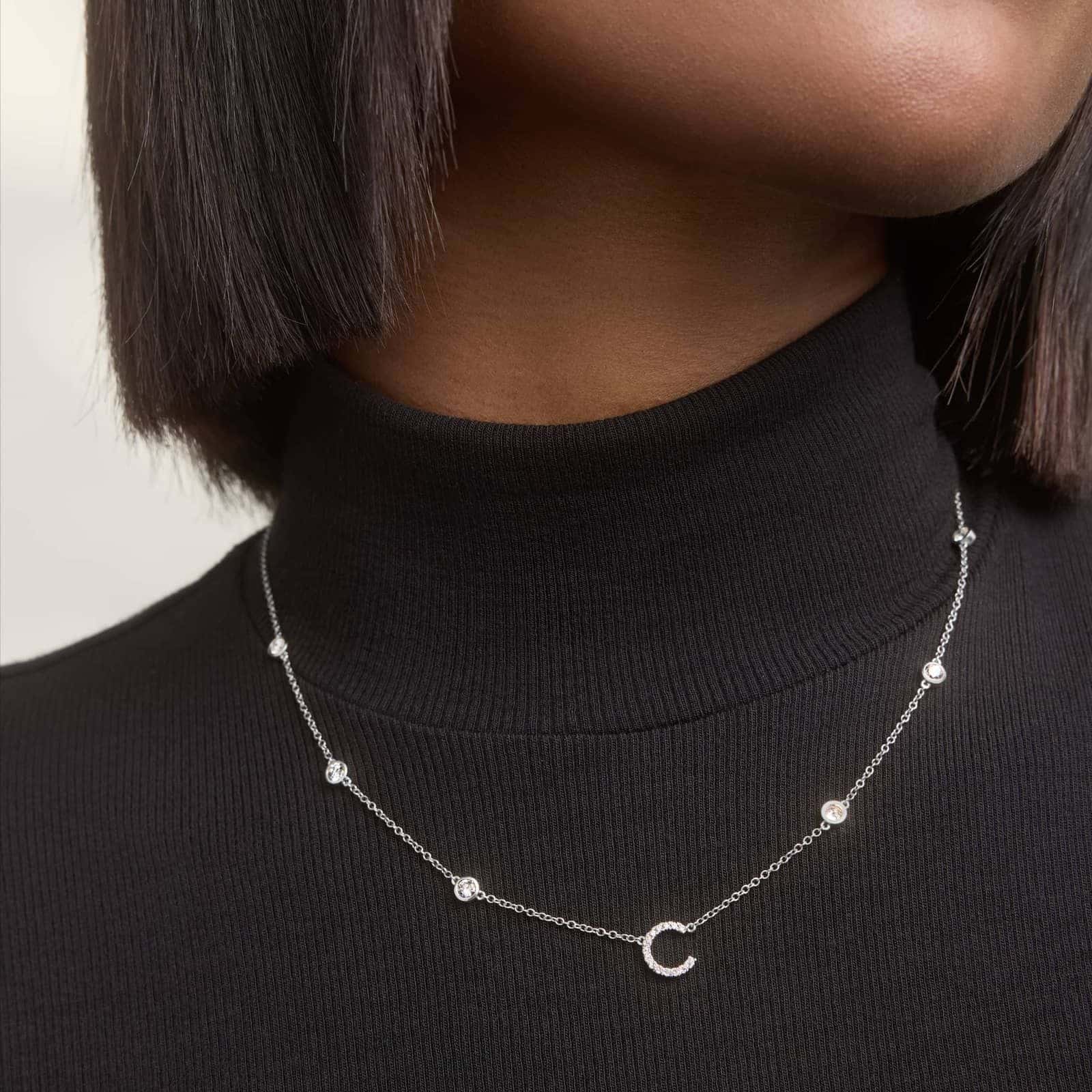 A personalized station initial necklace in 14K White Gold featuring 0.95 CTW lab-grown diamonds in a bezel setting, one of the best Luxury Push Present Ideas.