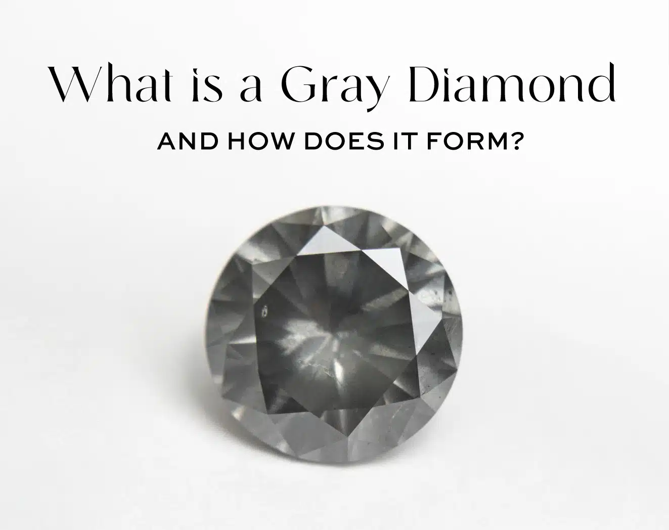 Featured image for the ultimate guide to gray diamonds. A close-up shot of a dark, round brilliant cut gray diamond, titled "What is a Gray Diamond and How Does it Form?". The image showcases the stone's sophisticated, moody gray body color.