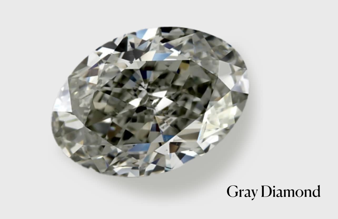 Close-up of a brilliant oval cut gray diamond, showcasing its unique subtle gray color and natural sparkle. This image illustrates the varied hues possible in natural gray diamonds, formed by elements like boron, hydrogen, or microscopic inclusions, a key aspect discussed in how gray diamonds are formed.