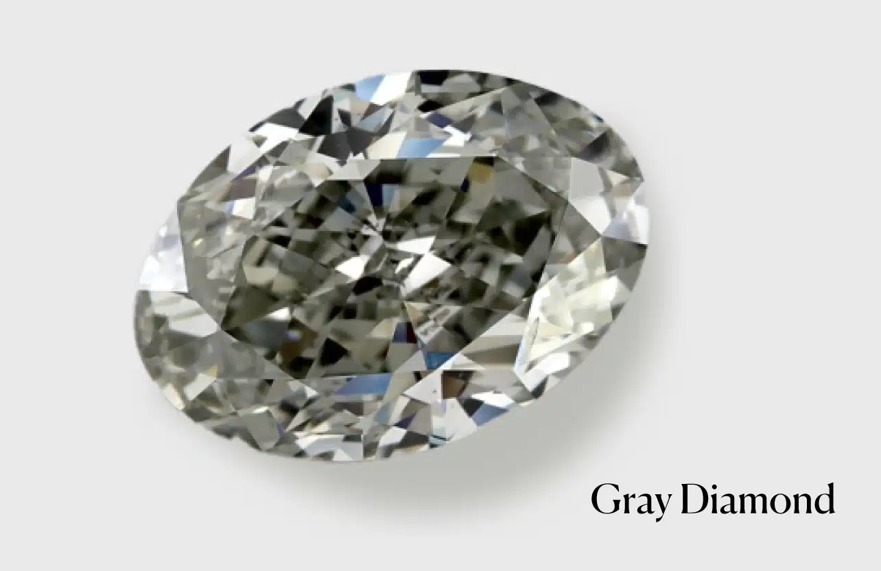 Close-up of a brilliant oval cut gray diamond, showcasing its unique subtle gray color and natural sparkle. This image illustrates the varied hues possible in natural gray diamonds, formed by elements like boron, hydrogen, or microscopic inclusions, a key aspect discussed in how gray diamonds are formed.