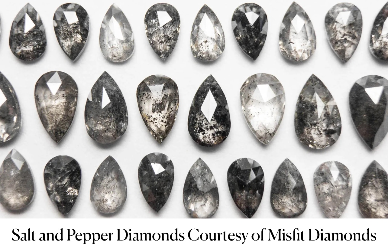 A grid of various pear-shaped salt and pepper diamonds, showcasing the visible black and white mineral inclusions that create their unique patterns. This image demonstrates the distinct artistic style of inclusion-based gray diamonds versus uniform Fancy Gray diamonds.