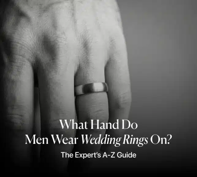 Close-up of a man's hand wearing a brushed metal wedding band on the left ring finger, with the article title overlay: "What Hand Do Men Wear Wedding Rings On? The Expert’s A-Z Guide."