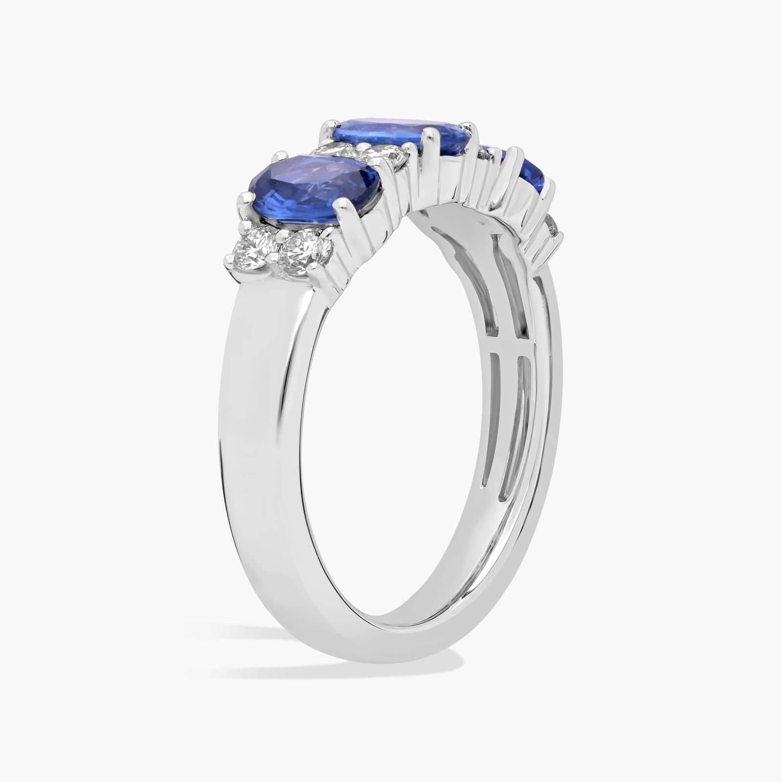 3-stone-diamond-rings-with-sapphires-14k-white-gold side view A 14K White Gold 3 Stone Diamond Rings With Sapphires ring (3.60 mm wide) featuring three Oval Blue Sapphires set in prongs, accented by 0.31 CTW Round Diamonds on the shank.