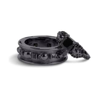 A set of Black Wedding Ring Sets His and Hers featuring a Princess Cut Black Moissanite Skull Engagement Ring and matching wedding band in 925 Sterling Silver with a Gun Metal finish.