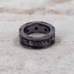 A set of Black Wedding Ring Sets His and Hers featuring a Princess Cut Black Moissanite Skull Engagement Ring and matching wedding band in 925 Sterling Silver with a Gun Metal finish.