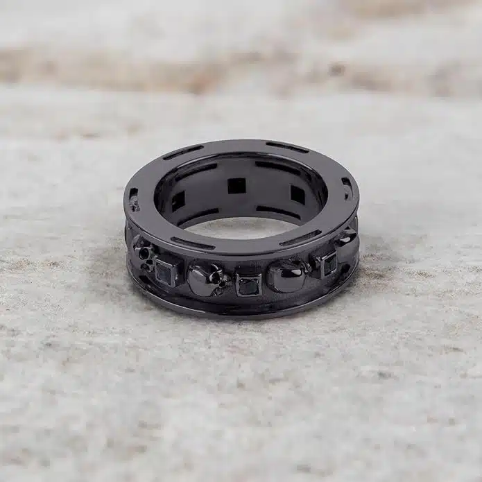 A set of Black Wedding Ring Sets His and Hers featuring a Princess Cut Black Moissanite Skull Engagement Ring and matching wedding band in 925 Sterling Silver with a Gun Metal finish.