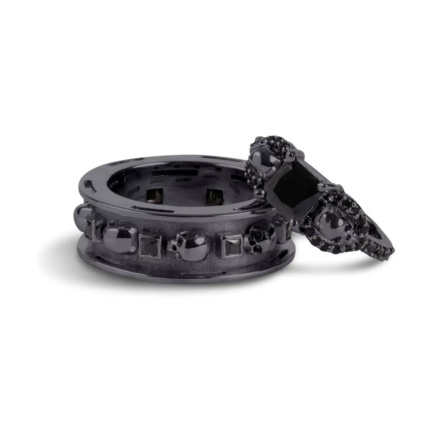 A set of Black Wedding Ring Sets His and Hers featuring a Princess Cut Black Moissanite Skull Engagement Ring and matching wedding band in 925 Sterling Silver with a Gun Metal finish.