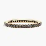 A Riviera Noir Pavé Black Diamond Black Wedding Rings For Women band (1.50mm) in 18K Yellow Gold with 0.50 CTW black diamonds.