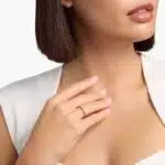 A Riviera Noir Pavé Black Diamond Black Wedding Rings For Women band (1.50mm) in 18K Yellow Gold with 0.50 CTW black diamonds in women hands view.