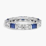 An Alternating East-West Emerald Cut Sapphire and Diamond Blue Wedding Rings For Women band (3.30mm) in 14K White Gold with over 2.5 CTW of stones.