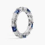 An Alternating East-West Emerald Cut Sapphire and Diamond Blue Wedding Rings For Women band (3.30mm) in 14K White Gold with over 2.5 CTW of stones.