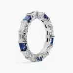 An Alternating East-West Emerald Cut Sapphire and Diamond Blue Wedding Rings For Women band (3.30mm) in 14K White Gold with over 2.5 CTW of stones.