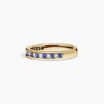 An 18K Yellow Gold Princess Cut Wedding Rings band (4.00 mm) featuring an alternating channel-set pattern of 0.5 CTW natural diamonds and blue sapphires.