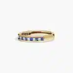 An 18K Yellow Gold Princess Cut Wedding Rings band (4.00 mm) featuring an alternating channel-set pattern of 0.5 CTW natural diamonds and blue sapphires.