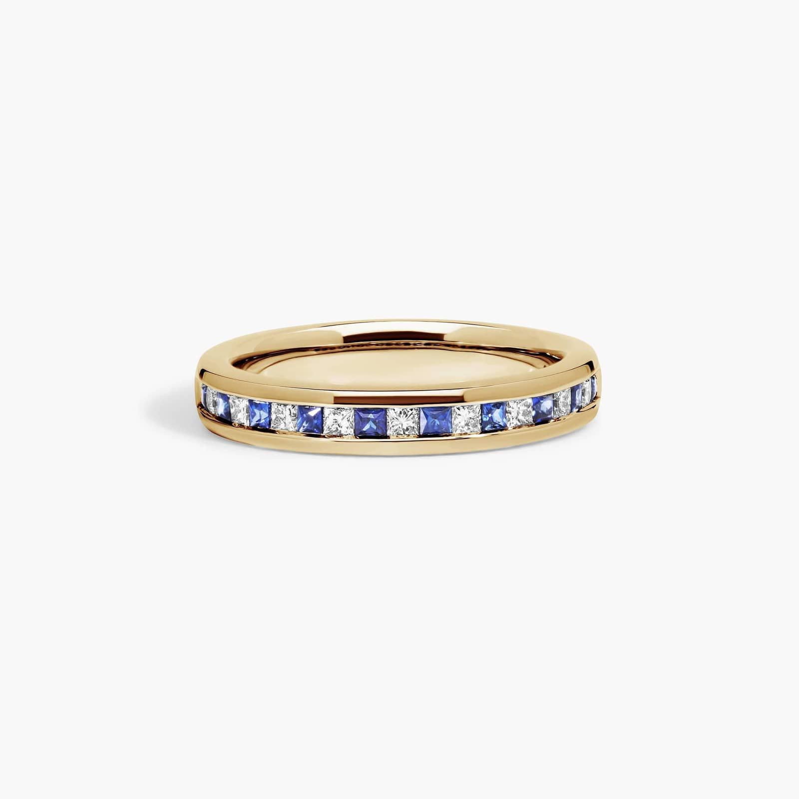 alternating-princess-cut-diamond-sapphire-yellow-gold-princess-cut-wedding-rings-18k An 18K Yellow Gold Princess Cut Wedding Rings band (4.00 mm) featuring an alternating channel-set pattern of 0.5 CTW natural diamonds and blue sapphires.