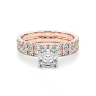 A 14K Rose Gold Cushion Cut Engagement Rings With Wedding Band set, featuring a large Cushion Cut Lab-Grown Diamond solitaire and a 0.5 ct diamond matching wedding band.