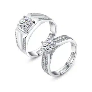 A set of Unique Matching Wedding Bands His and Hers in 0.925 Sterling Silver, featuring Round Natural Diamonds with D Color and VVS1 Clarity in a 1.0 Carat solitaire style.
