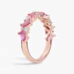 A 14K Rose Gold and Pink Sapphire Ring featuring 7 Baguette Pink Sapphires and 6 Round Diamonds (0.18 CTW) set in prongs, creating a romantic, emerald-style look on a 2.50 mm band.