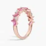 A 14K Rose Gold and Pink Sapphire Ring featuring 7 Baguette Pink Sapphires and 6 Round Diamonds (0.18 CTW) set in prongs, creating a romantic, emerald-style look on a 2.50 mm band.