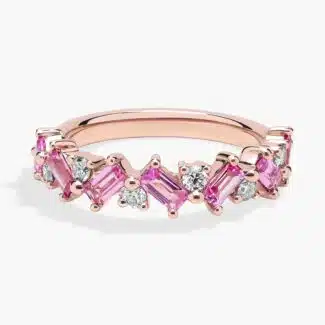 A 14K Rose Gold and Pink Sapphire Ring featuring 7 Baguette Pink Sapphires and 6 Round Diamonds (0.18 CTW) set in prongs, creating a romantic, emerald-style look on a 2.50 mm band.