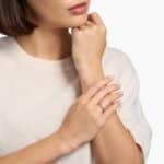 A 14K Rose Gold and Pink Sapphire Ring featuring 7 Baguette Pink Sapphires and 6 Round Diamonds (0.18 CTW) set in prongs, creating a romantic, emerald-style look on a 2.50 mm band.