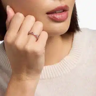 A 14K Rose Gold and Pink Sapphire Ring featuring 7 Baguette Pink Sapphires and 6 Round Diamonds (0.18 CTW) set in prongs, creating a romantic, emerald-style look on a 2.50 mm band.