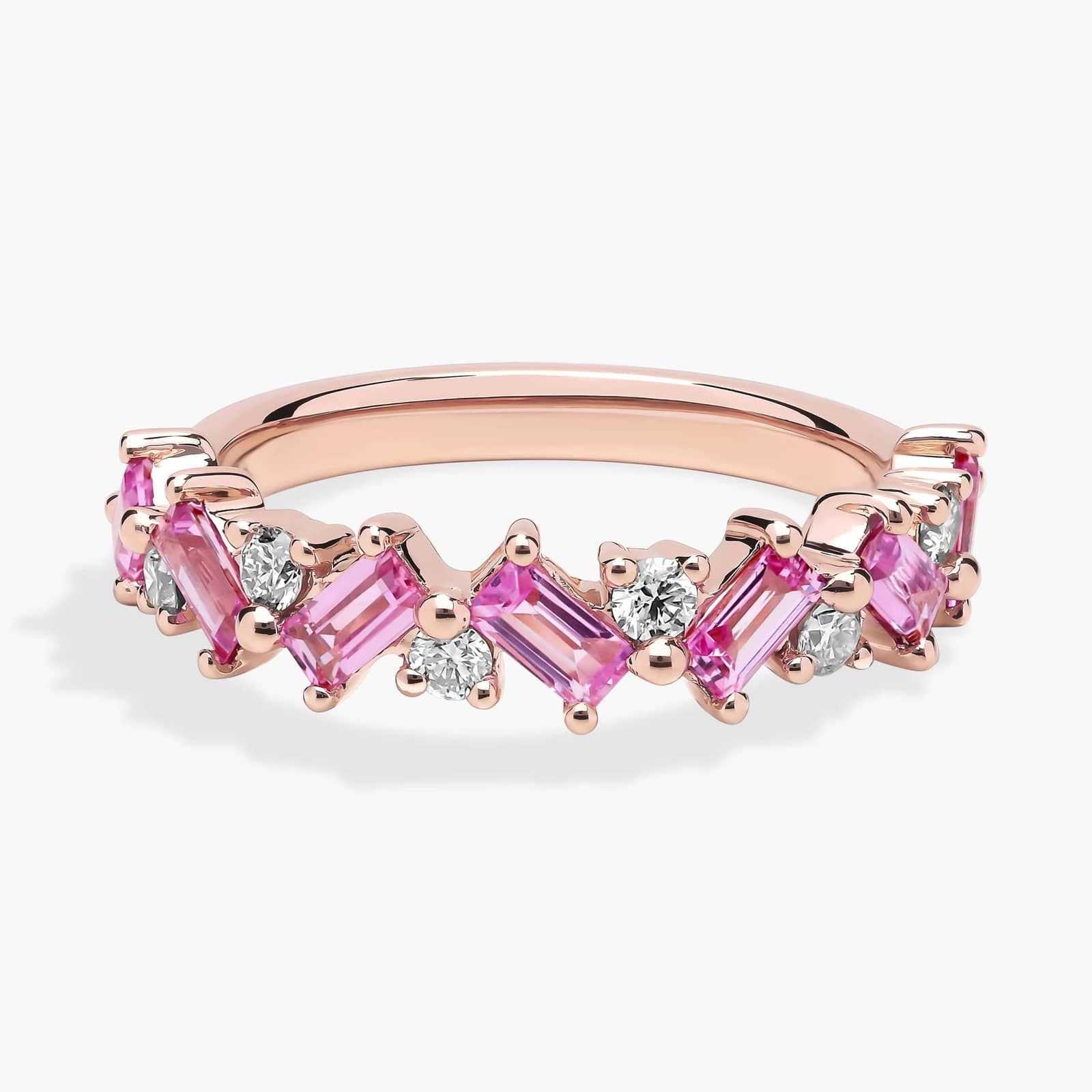 diamond-rose-gold-and-pink-sapphire-ring-emerald-cut-14k A 14K Rose Gold and Pink Sapphire Ring featuring 7 Baguette Pink Sapphires and 6 Round Diamonds (0.18 CTW) set in prongs, creating a romantic, emerald-style look on a 2.50 mm band.