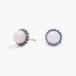 A pair of 14K White Gold Pearl and Sapphire Drop Earrings (Halo Stud style) featuring 7 mm Freshwater Cultured Pearls surrounded by a halo of 32 Round Blue Sapphires, secured with Push Backs.