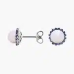 A pair of 14K White Gold Pearl and Sapphire Drop Earrings (Halo Stud style) featuring 7 mm Freshwater Cultured Pearls surrounded by a halo of 32 Round Blue Sapphires, secured with Push Backs.