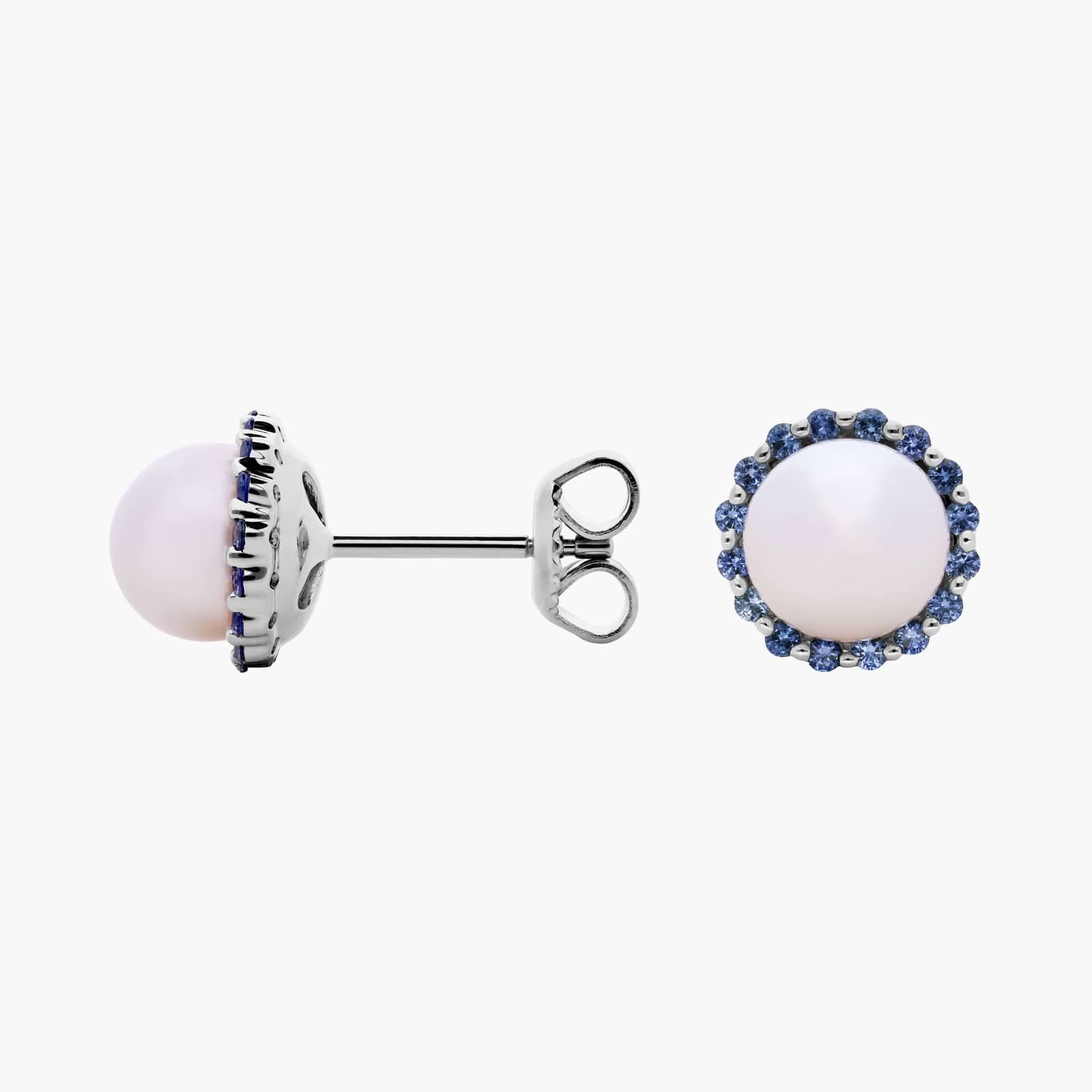 A pair of 14K White Gold Pearl and Sapphire Drop Earrings (Halo Stud style) featuring 7 mm Freshwater Cultured Pearls surrounded by a halo of 32 Round Blue Sapphires, secured with Push Backs.