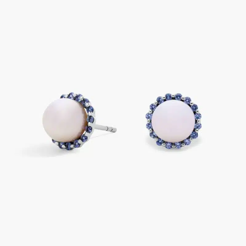 A pair of 14K White Gold Pearl and Sapphire Drop Earrings (Halo Stud style) featuring 7 mm Freshwater Cultured Pearls surrounded by a halo of 32 Round Blue Sapphires, secured with Push Backs.