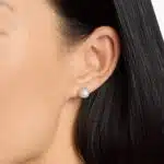 A pair of 14K White Gold Pearl and Sapphire Drop Earrings (Halo Stud style) featuring 7 mm Freshwater Cultured Pearls surrounded by a halo of 32 Round Blue Sapphires, secured with Push Backs.