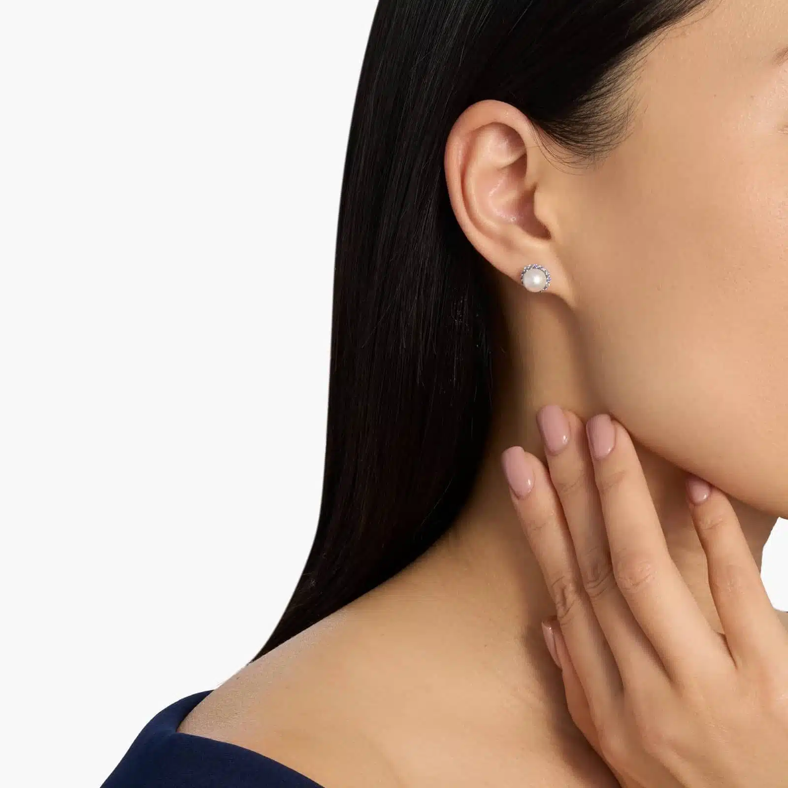 A pair of 14K White Gold Pearl and Sapphire Drop Earrings (Halo Stud style) featuring 7 mm Freshwater Cultured Pearls surrounded by a halo of 32 Round Blue Sapphires, secured with Push Backs.