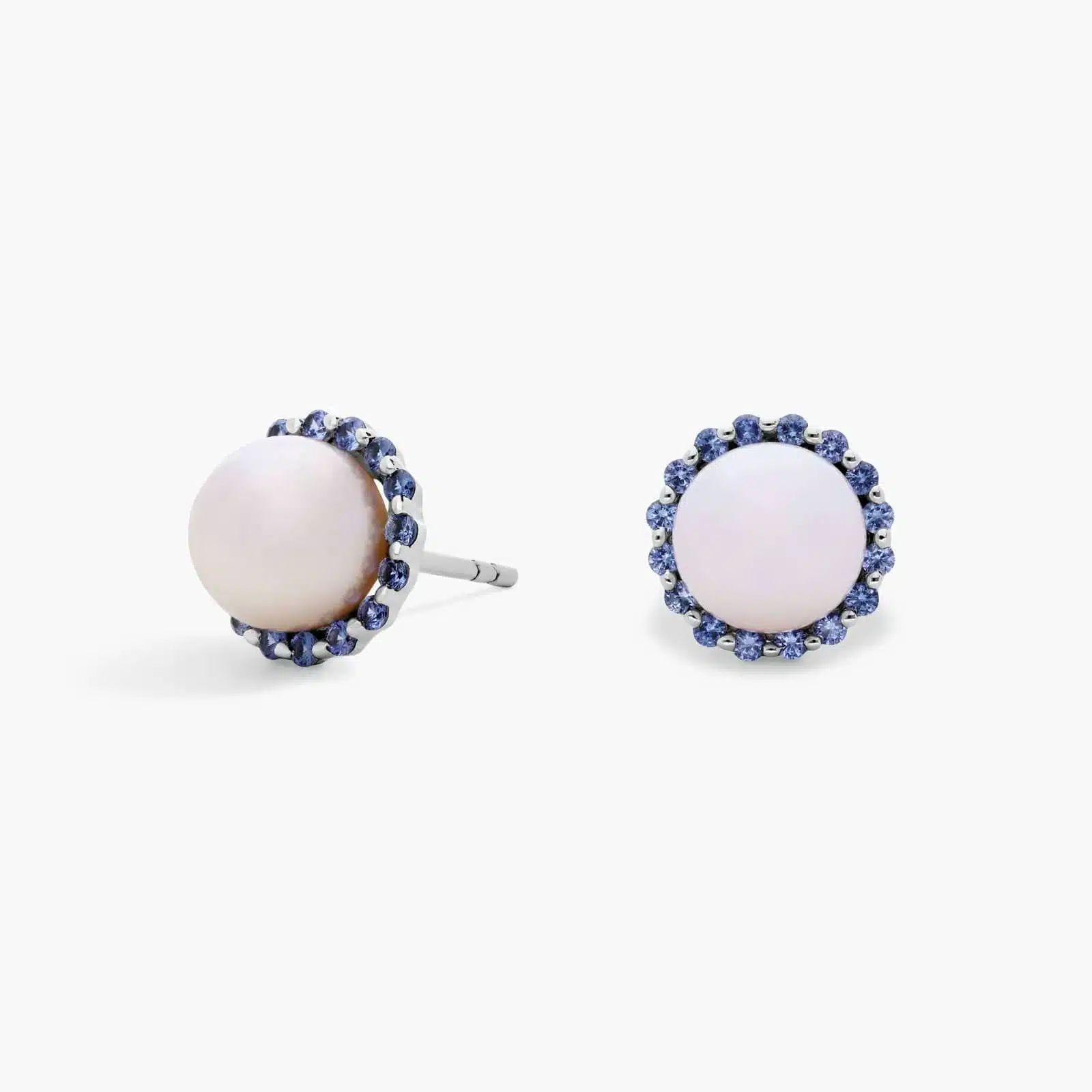 A pair of 14K White Gold Pearl and Sapphire Drop Earrings (Halo Stud style) featuring 7 mm Freshwater Cultured Pearls surrounded by a halo of 32 Round Blue Sapphires, secured with Push Backs.