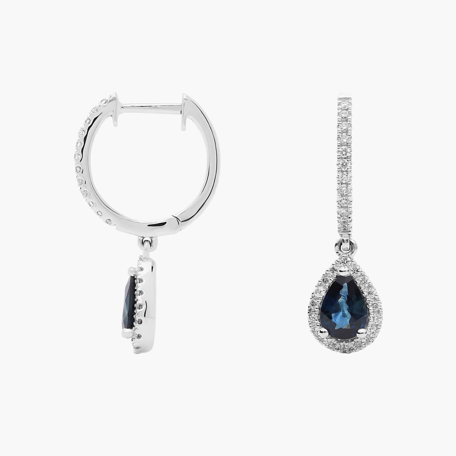 halo-pear-sapphire-and-diamond-dangle-earrings-14k-1-22-ctw 2 A pair of 14K White Gold Sapphire and Diamond Dangle Earrings featuring two 6x4 mm Pear Shaped Blue Sapphires (1 CT total) and a 0.22 CTW Round Diamond Halo, secured with Hinged Snap Backs.