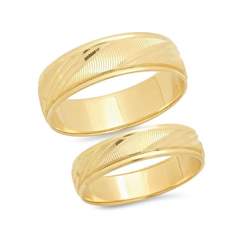A set of solid 14K Yellow Gold Wedding Ring Sets His and Hers 14K Gold bands with a Laser Cut Design (6mm men's, 4.5mm women's).